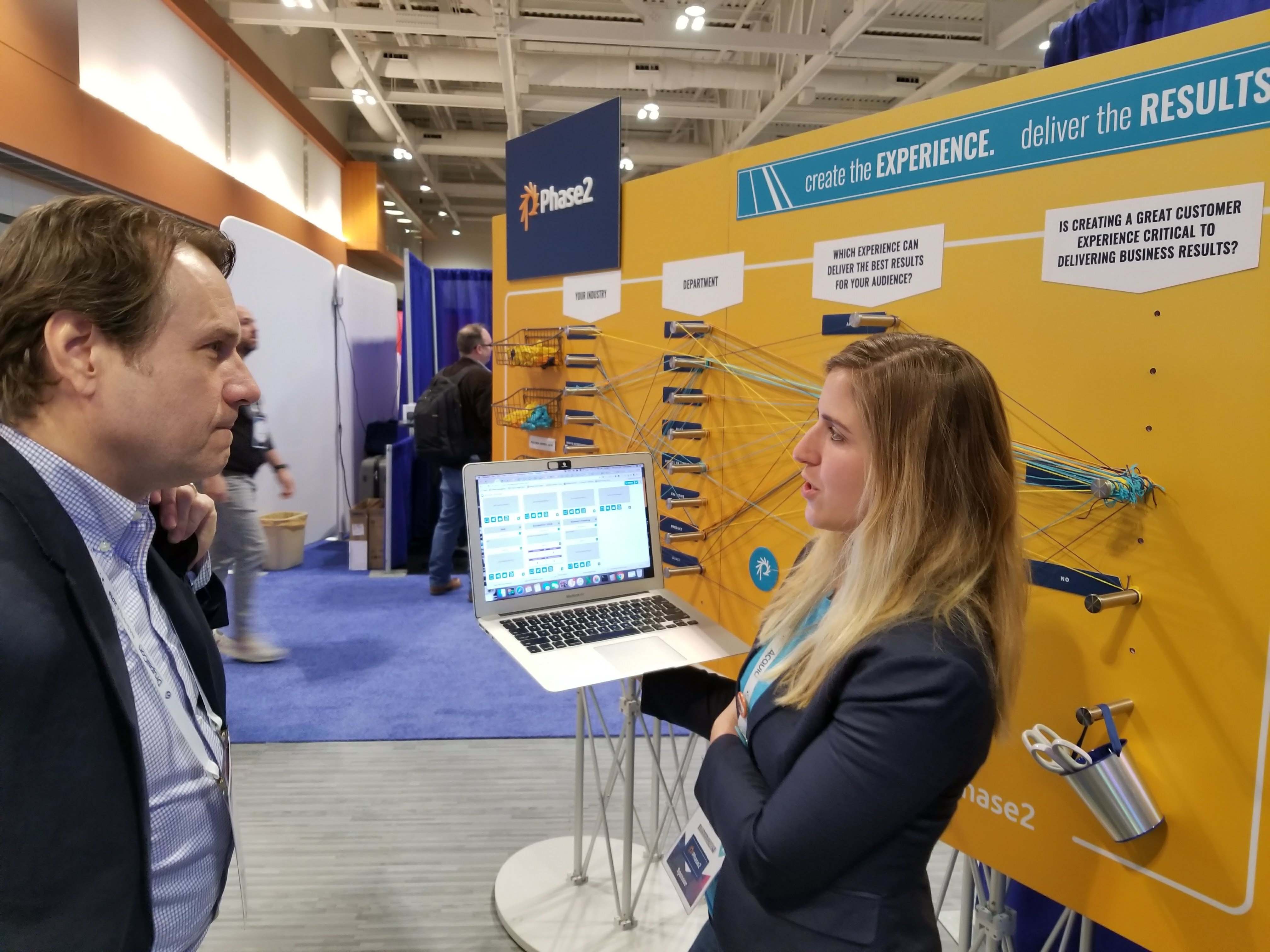 Phase2, Director of Marketing discussing customer experience at DrupalCon Booth