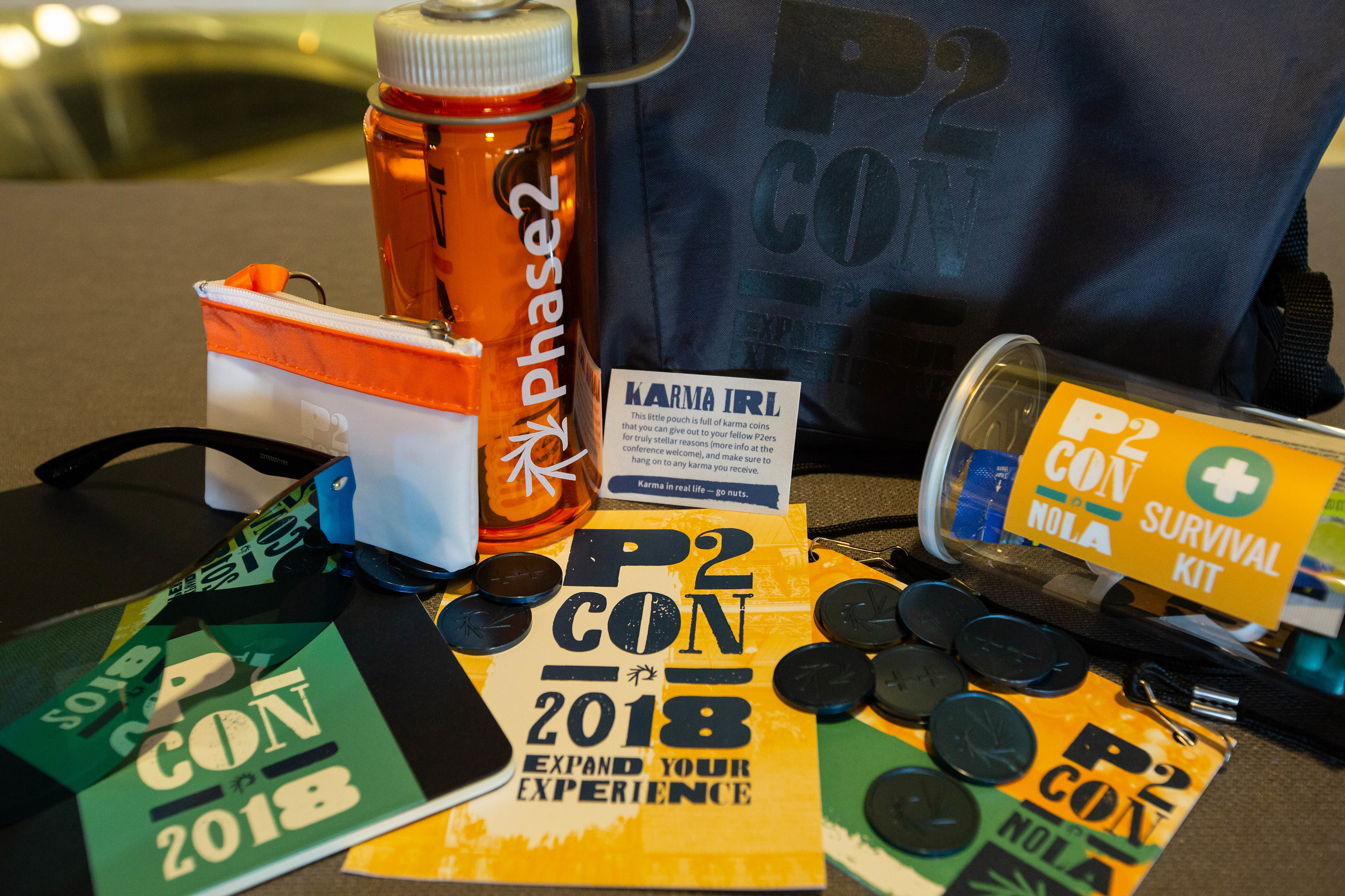 water bottle, notebook, backpack, notebook, and sunglasses with Expand Your Experience event theme