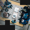 Aerial view of coworkers with laptops seated on couches and chairs around a coffee table