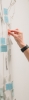 Hand placing notes on a white board