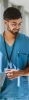 Nurse smiling with tablet while walking