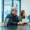 Marshall Schoenthal smiles with notebook at office