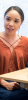 Woman in orange shirt speaking to others at a table