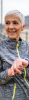Woman pausing from exercising, looking to the left while pausing her smart device on her wrist