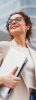 woman holding laptop looking to her upper left